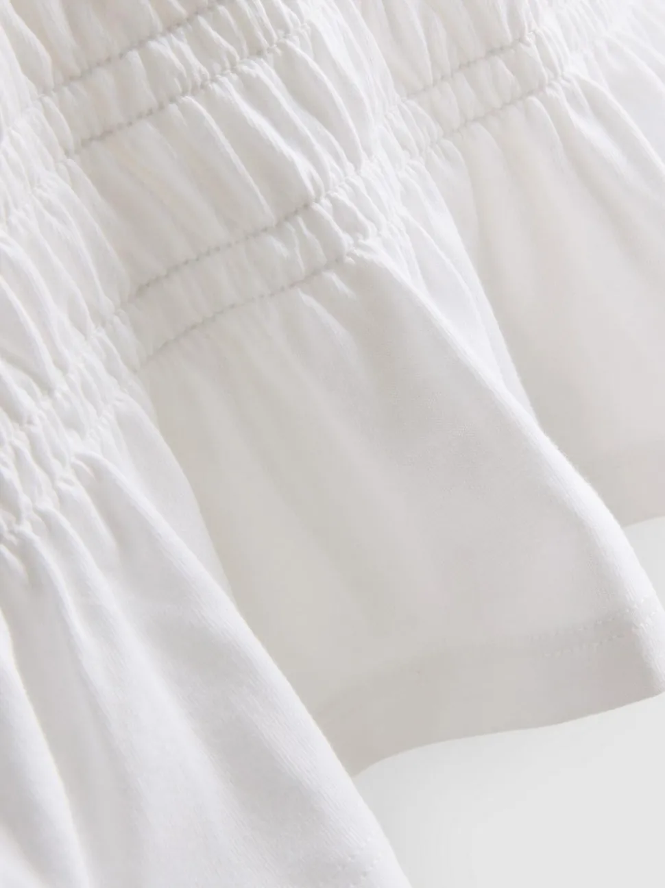 7–15 Jahre | Gesmoktes T-Shirt mit Schößchen